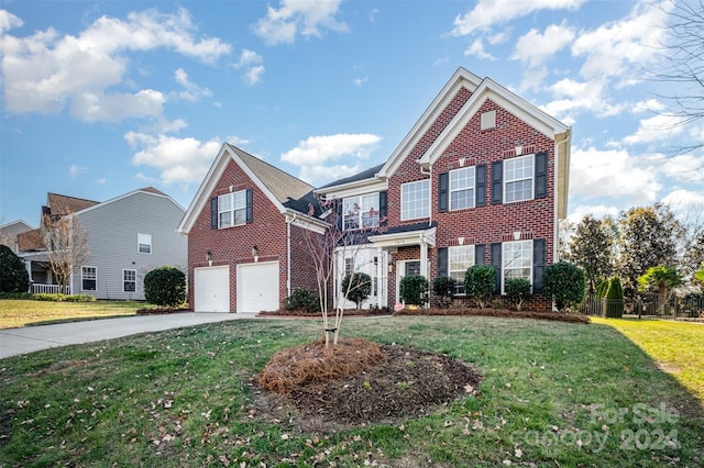 view of front of home featuring a garage and a front lawn