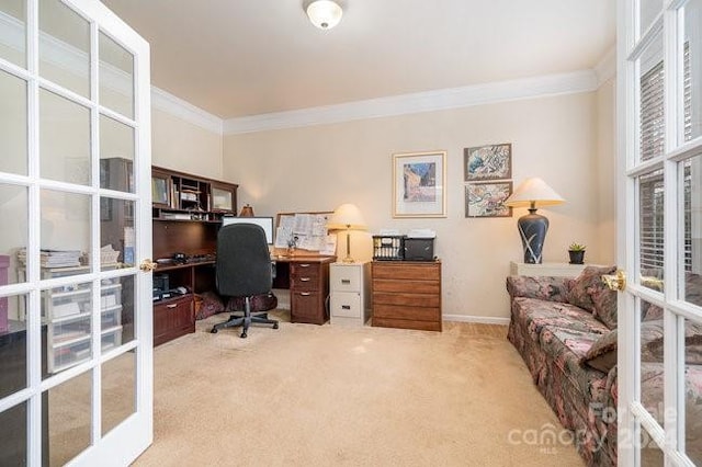 carpeted office space with crown molding and french doors