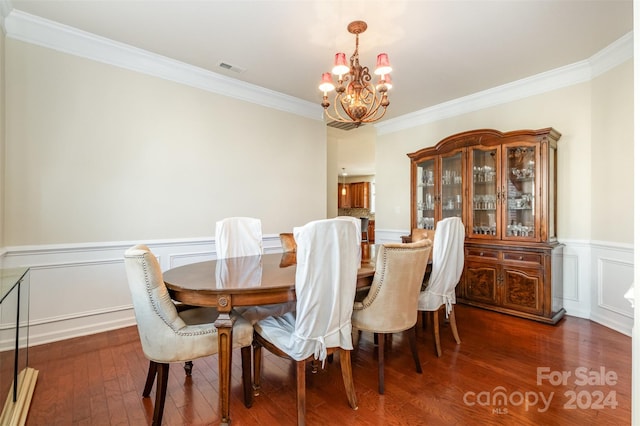 dining area featuring a notable chandelier, dark hardwood / wood-style floors, and ornamental molding