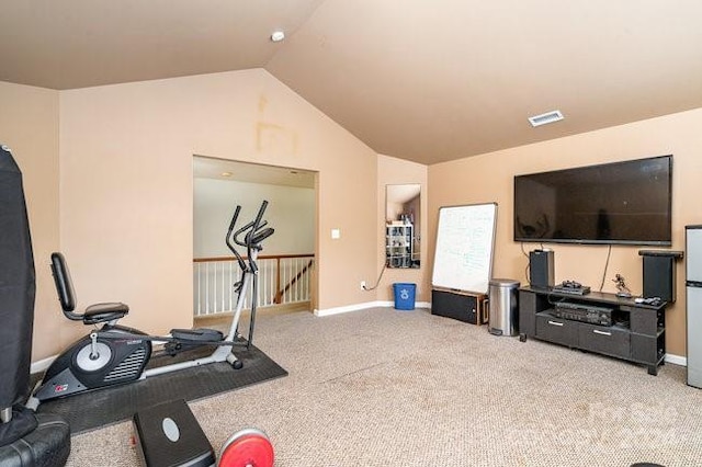 workout room featuring light colored carpet and vaulted ceiling