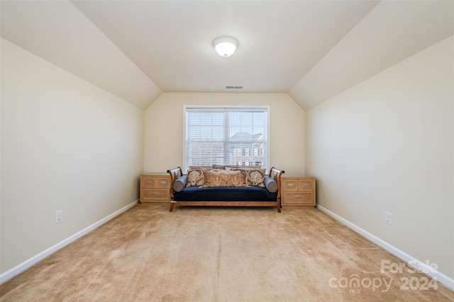 living area with light colored carpet and lofted ceiling