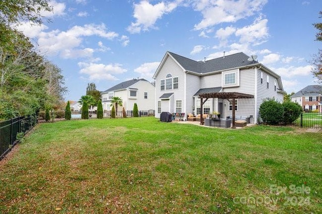 rear view of property featuring a pergola and a lawn