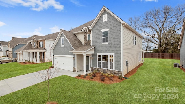 view of front of house featuring a garage, cooling unit, and a front lawn