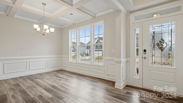 entrance foyer with coffered ceiling, a wealth of natural light, wood-type flooring, and beam ceiling