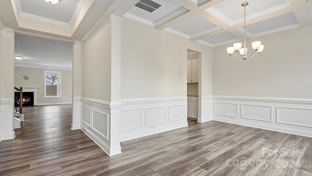 unfurnished room featuring hardwood / wood-style floors, coffered ceiling, beamed ceiling, and ornamental molding