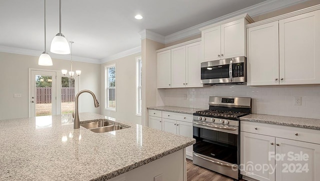 kitchen featuring white cabinetry, sink, light stone counters, and stainless steel appliances