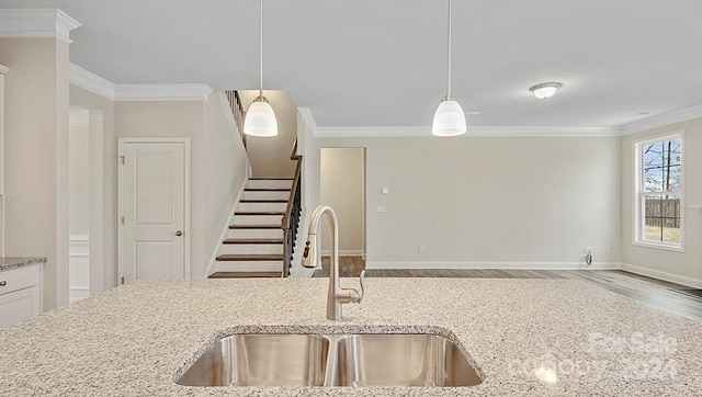 kitchen featuring hanging light fixtures, light stone countertops, and wood-type flooring