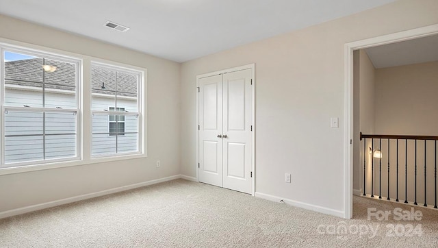 unfurnished bedroom with carpet flooring and a closet