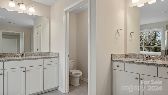 bathroom featuring vanity, tile patterned floors, and toilet