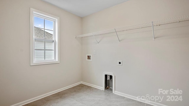 laundry room featuring hookup for an electric dryer, hookup for a washing machine, and light tile patterned floors