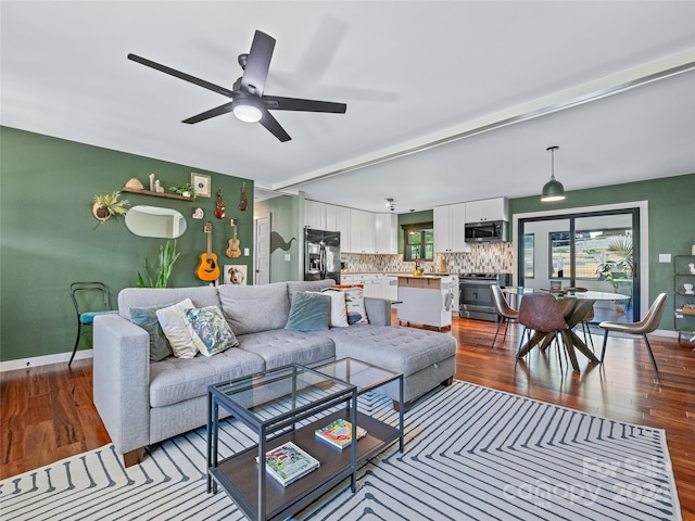 living room with ceiling fan and wood-type flooring