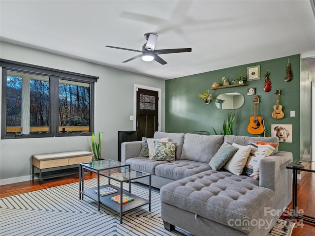 living room featuring ceiling fan and wood-type flooring