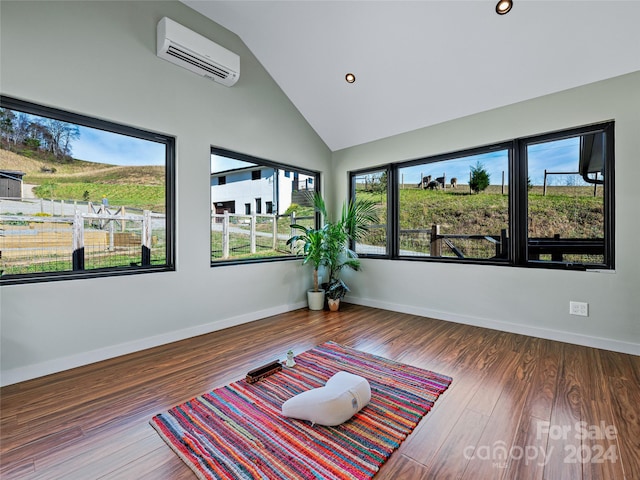 unfurnished room featuring dark wood-type flooring, high vaulted ceiling, and a wall mounted AC