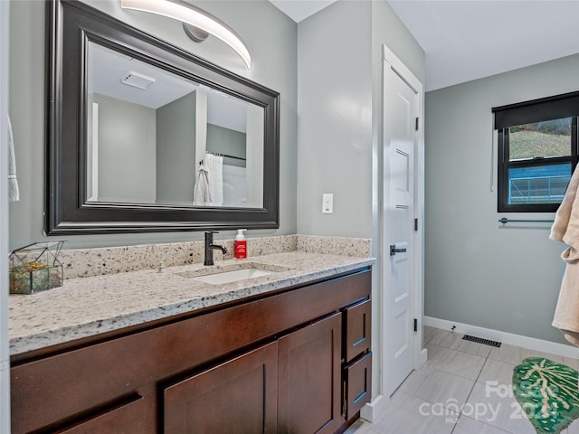 bathroom featuring tile patterned flooring and vanity