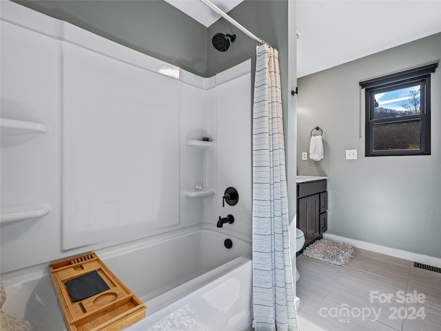 bathroom featuring tile patterned flooring, vanity, and shower / bath combo with shower curtain