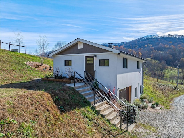 view of front of property with a mountain view and a garage