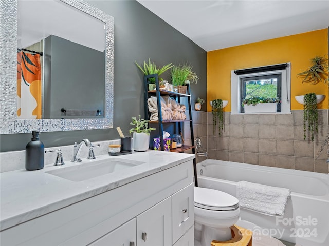 bathroom with vanity, a bath, and toilet