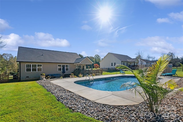 view of swimming pool featuring a lawn and a patio area