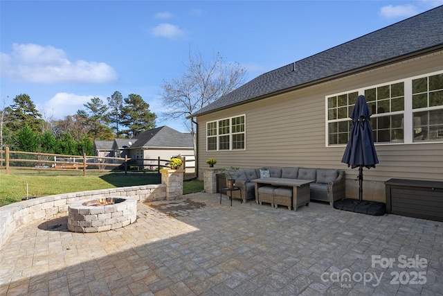 view of patio / terrace with an outdoor living space with a fire pit