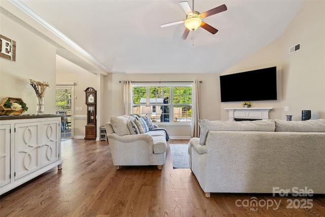 living room with dark hardwood / wood-style floors, vaulted ceiling, and ceiling fan