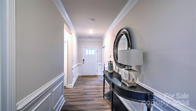 entryway with dark wood-type flooring and crown molding