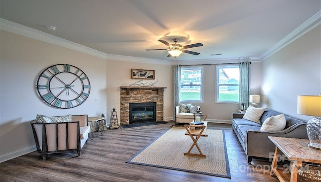 living room featuring a fireplace, dark hardwood / wood-style floors, crown molding, and ceiling fan