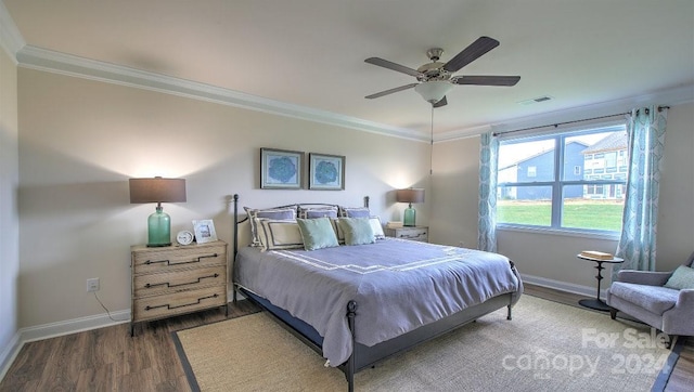 bedroom with ceiling fan, dark hardwood / wood-style floors, and ornamental molding