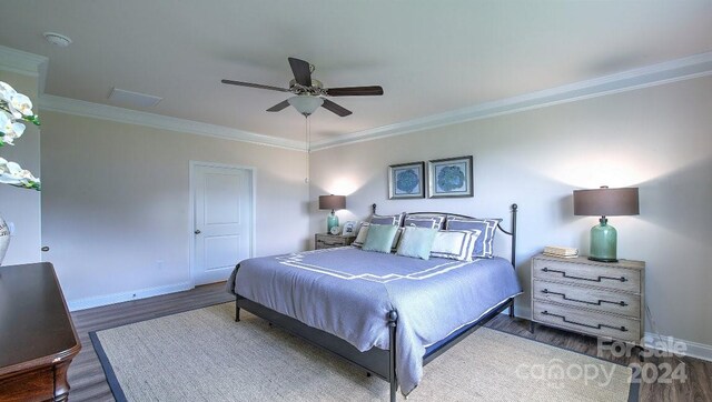 bedroom with crown molding, dark hardwood / wood-style floors, and ceiling fan