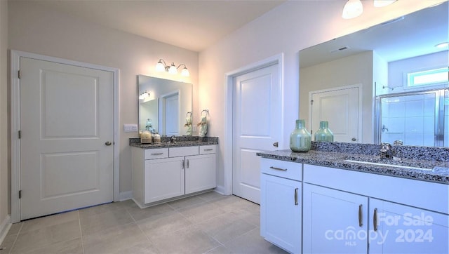 bathroom featuring an enclosed shower, vanity, and tile patterned floors