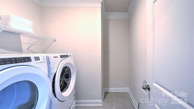 laundry area with tile patterned flooring, washer and dryer, and crown molding