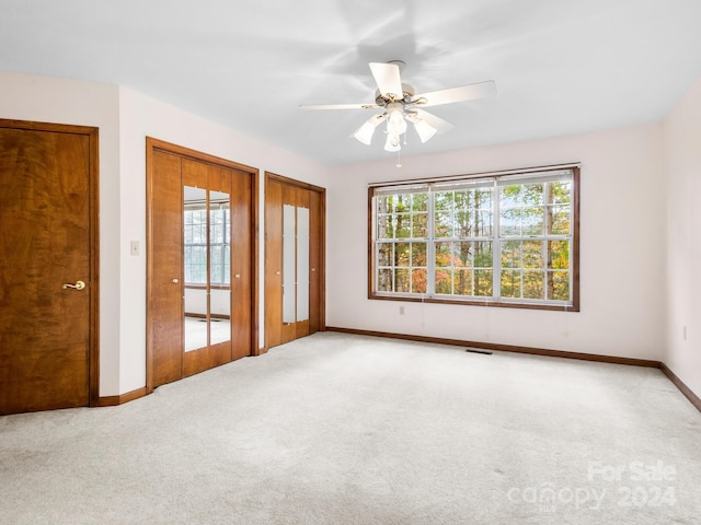 empty room with carpet floors and ceiling fan