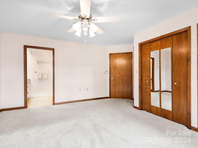 unfurnished bedroom with light colored carpet, ceiling fan, and connected bathroom