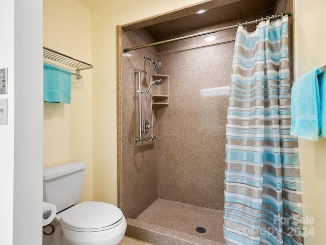 bathroom with a shower with curtain and toilet