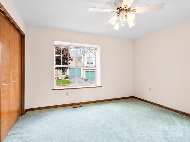 interior space featuring a closet, carpet, and ceiling fan