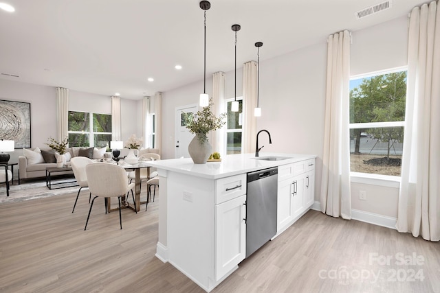 kitchen featuring white cabinetry, pendant lighting, sink, dishwasher, and light hardwood / wood-style flooring