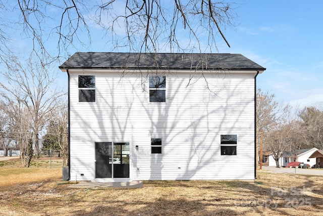 rear view of property featuring a yard