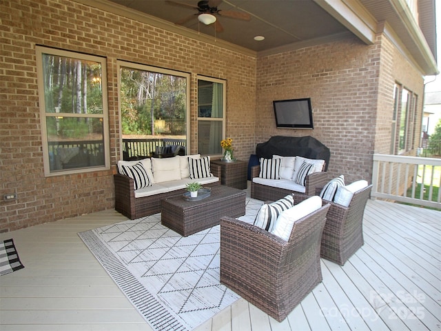 deck with outdoor lounge area and ceiling fan