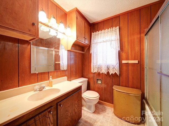 full bathroom with vanity, toilet, and wooden walls