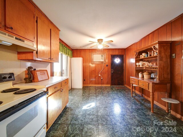 kitchen featuring ceiling fan, a wall unit AC, electric stove, and wooden walls