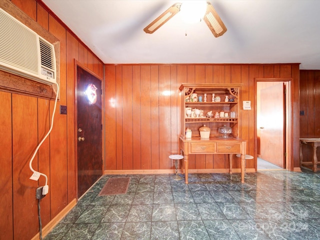 foyer entrance featuring ceiling fan, wood walls, and a wall mounted AC