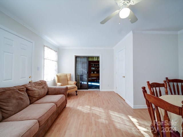 living room featuring light wood-type flooring, ceiling fan, and ornamental molding