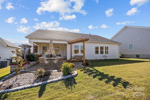 rear view of property featuring central air condition unit, a lawn, and a patio area