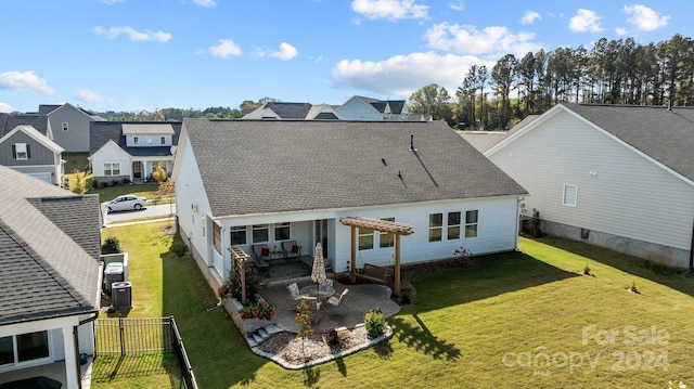 back of house featuring central air condition unit, a lawn, and a patio area