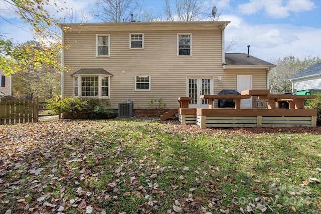 back of house with central AC unit and a wooden deck