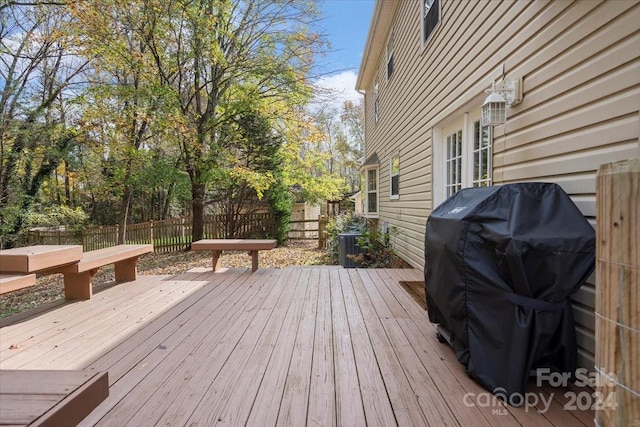 wooden deck featuring a grill