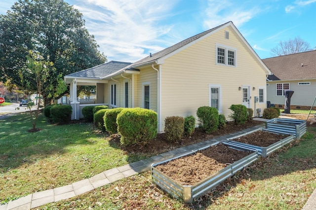 402 W 7th St, Newton, NC 28658 - view of home's exterior featuring a garden, a lawn, and a shingled roof