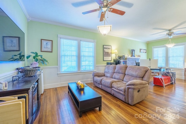 living room featuring hardwood / wood-style flooring, ceiling fan, and ornamental molding