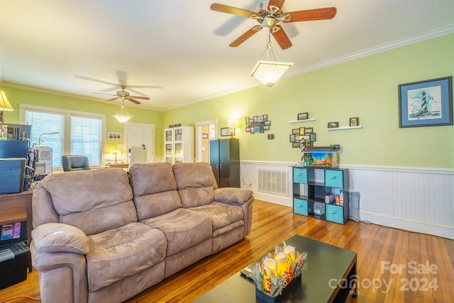 living room with ceiling fan, ornamental molding, and hardwood / wood-style flooring