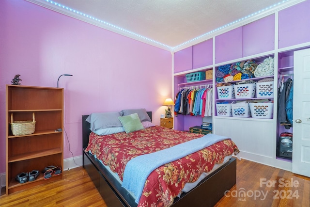 bedroom featuring wood-type flooring and a closet