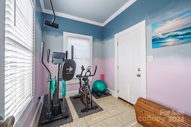 exercise area with light tile patterned floors and ornamental molding